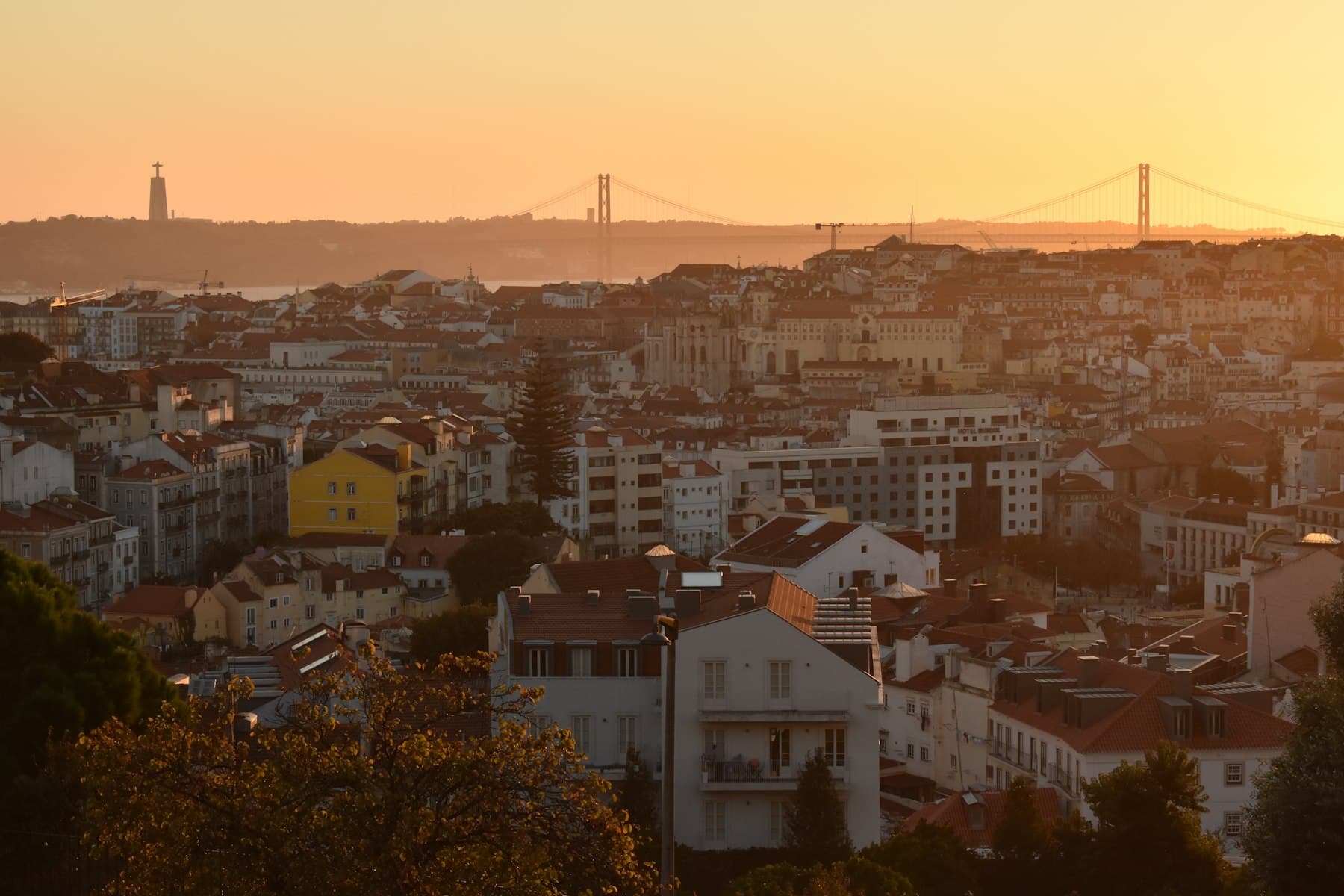 Golden sunset over Lisbon with the 25 de Abril bridge beyond